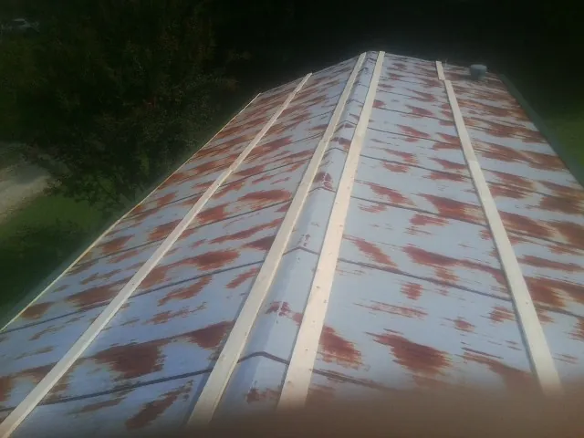 Rusted metal roof panels with new wood purlins before replacement — Storm Damage Roof Repair in Dundee by Roofing Brothers